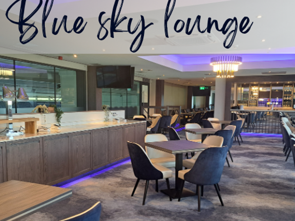 Meeting room with blue and cream carpets, blue velvet chairs and wooden tables. Text across the picture reads Blue Sky Lounge