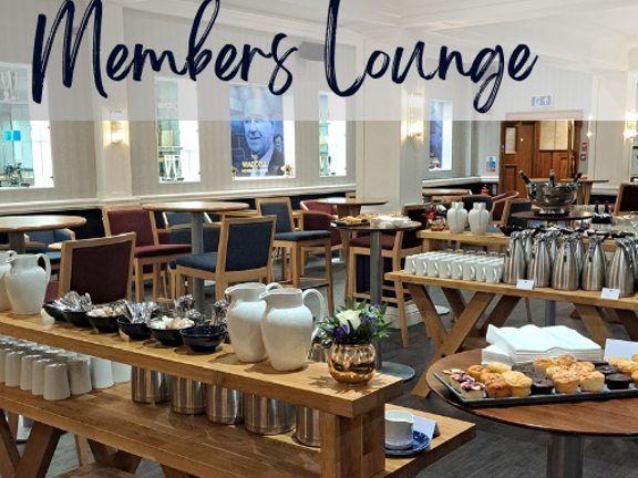 Bright room set up with tea/coffee and pastries for a tea break. Text on top reads Members Lounge.