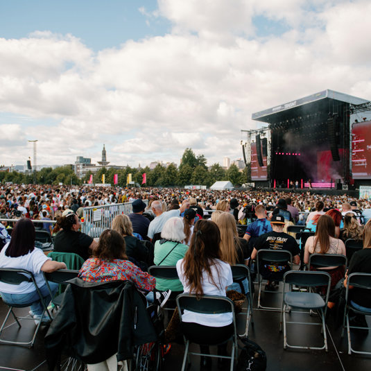 Attendees seated in the accessible area watching the TRNSMT main stage