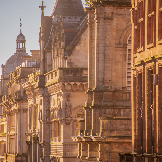 Series of building facades down Buchannan Street in the evening sunshine