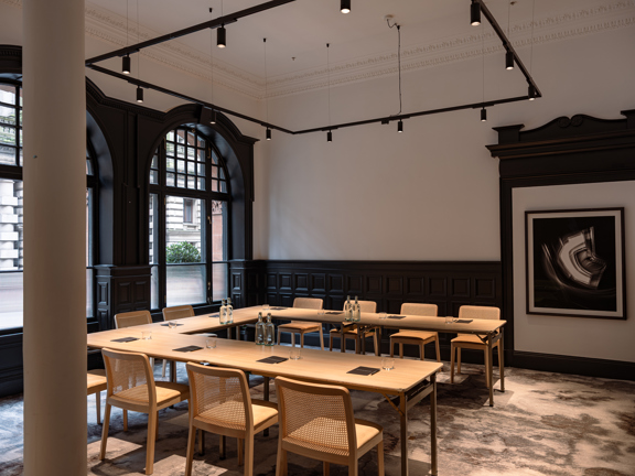 The Bell Boardroom, half height wooden panelling and large arched windows.
