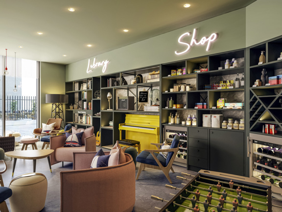 A cosy library and shop space featuring shelves filled with books and various products, including snacks and personal care items. A bright yellow piano adds a pop of colour, while comfortable seating invites relaxation and social interaction.
