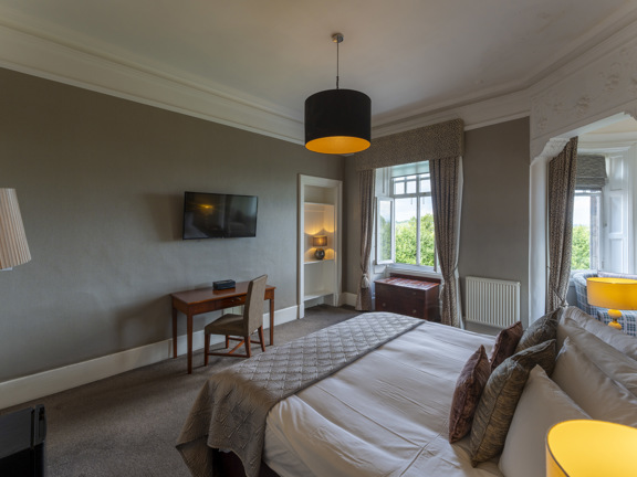 large, period style hotel bedroom with king-size bed