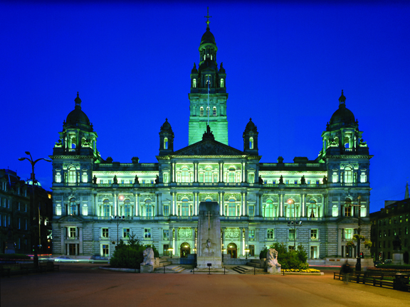 Front view of City Chambers Building and Cenotaph monument, lit up at night 