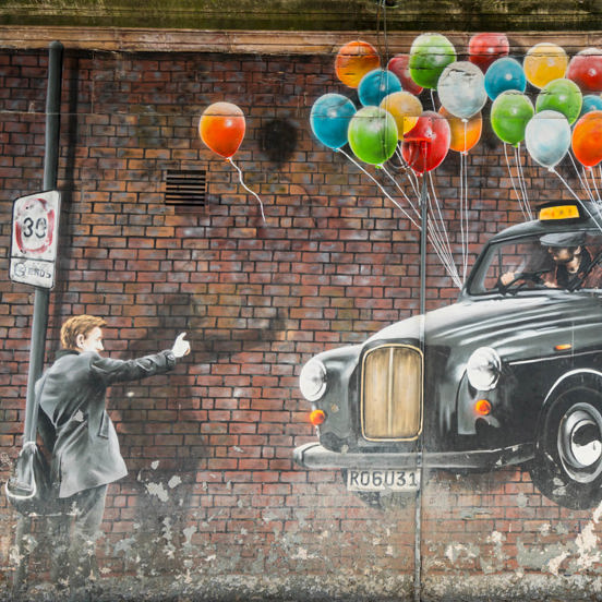 Mural of a man hailing a floating black cab, with colourful balloons tied to its wingmirrors