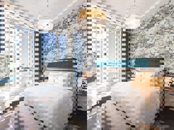 Bright and light hotel bedroom at Radisson Blu with kingsize bed and floor to ceiling windows.