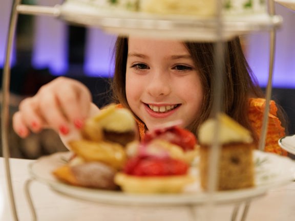 girl smiling and eating cake