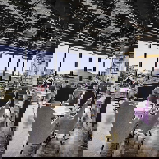 Hotel with occasional seating and floor to ceiling windows overlooking the SEC & Hydro in Glasgow. 