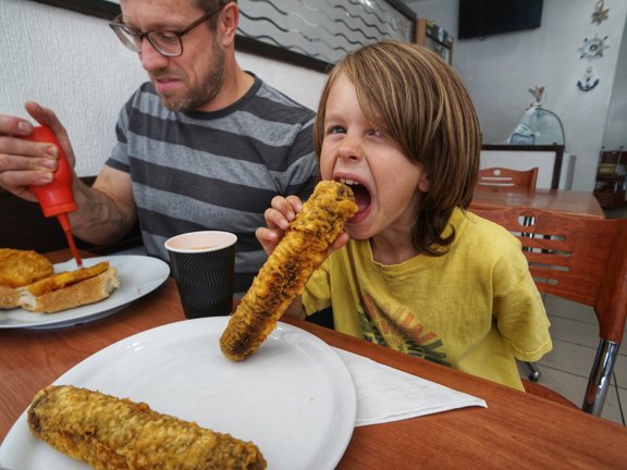 People eating battered Haggis