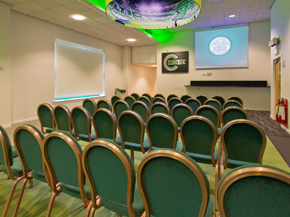 Lounge with chairs in rows set up to watch projector/ screen