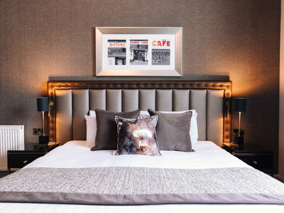 Luxury bedroom with ambient lighting and décor in tonal beige shades.