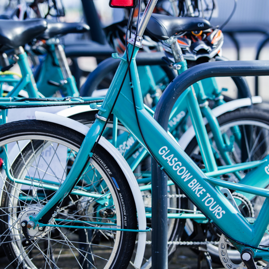 Row of teal coloured bikes reading Glasgow Bike Tours on the frame