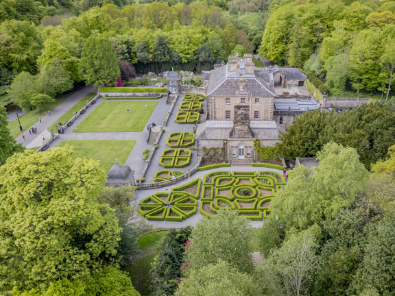 Aerial view of Georgian-style Pollok House with its manicured formal garden, set within the greenery of Pollok Country Park