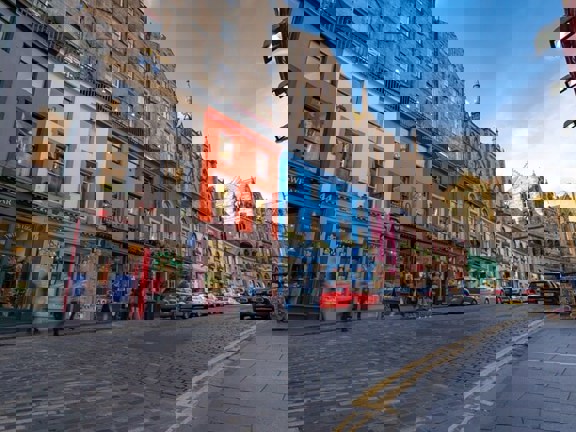 Street in Edinburgh with colourful buildings and cobbled street