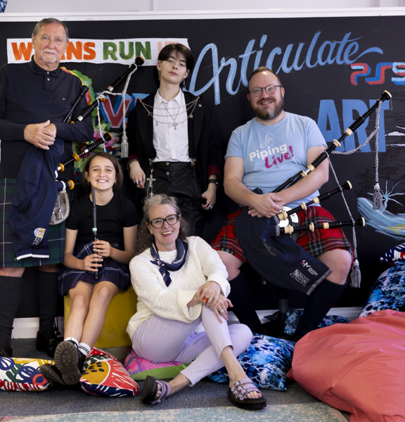 5 people standing and sitting with musical instruments in front of a coloured background