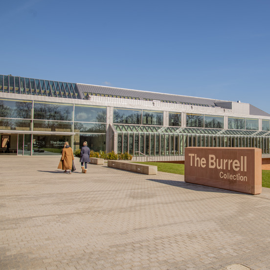 Two visitors entering glass structure of the The Burrell Collection