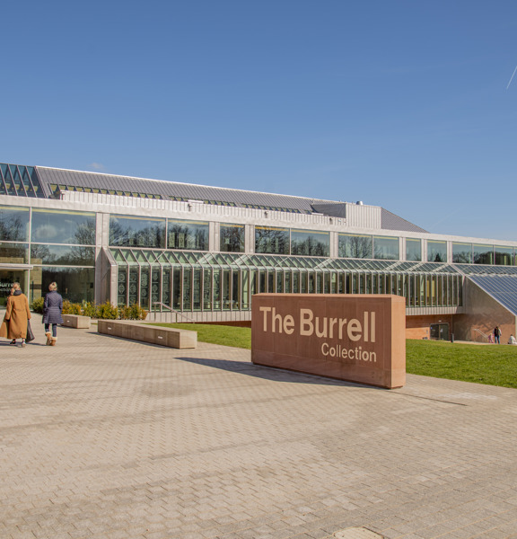 Two visitors entering glass structure of the The Burrell Collection