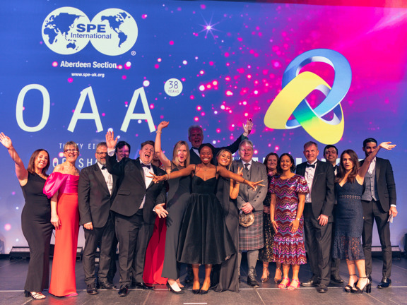 Award winners on a stage celebrating