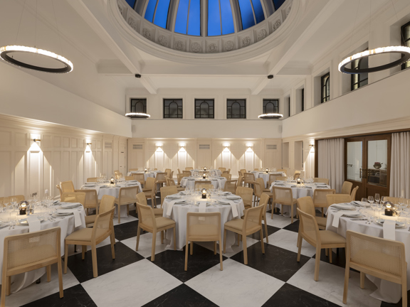 Dinner setting in The Collectors Hall - domed ceiling, checkerboard flooring, cream walls, round tables with white linen and pale wooden chairs. 