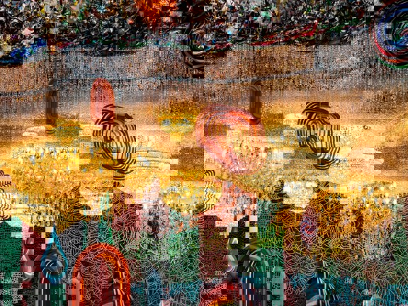 A contemporary art installation which features chandeliers and beading hanging from the ceiling in Tramway, Glasgow.