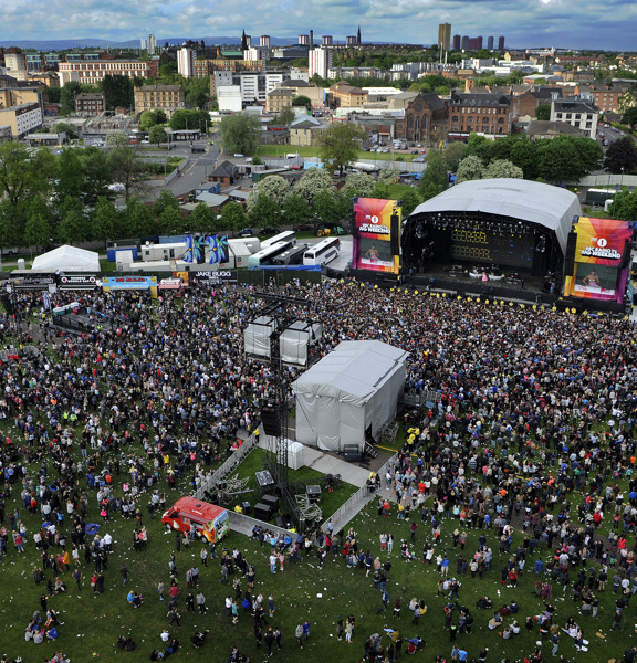 Aerial view of Glasgow Green, a crowd is gathered in front of a covered stage at Radio 1's Big Weekend.