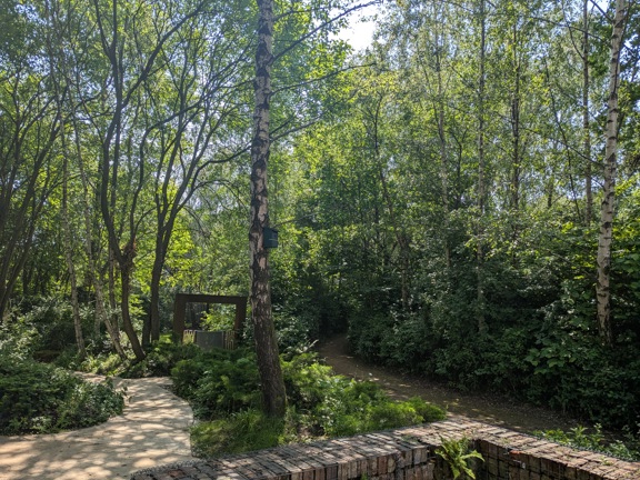 Image of wooded garden area with path leading through trees