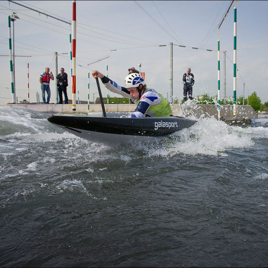 man in wild water kayak on a slalom course