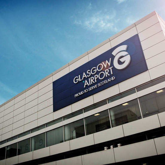 Modern square building with Glasgow Airport sign and logo