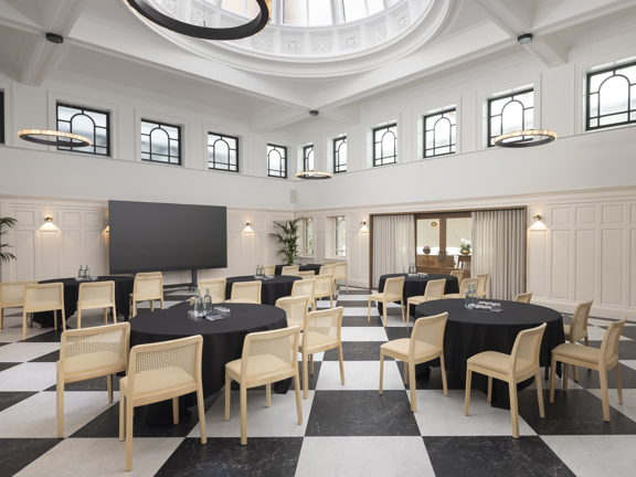Large event and meeting room with domed ceiling and checkerboard flooring.