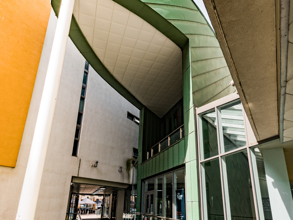 Main entrance to The Boardwalk with striking corner canopy and door. 