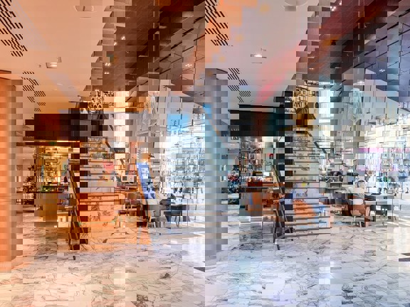 Marbled floor hotel reception area with floor to ceiling windows.