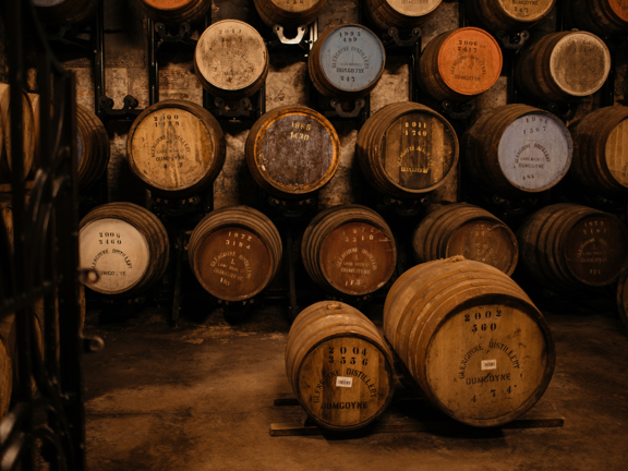 Whisky distillery warehouse housing multiple barrels of whisky. 