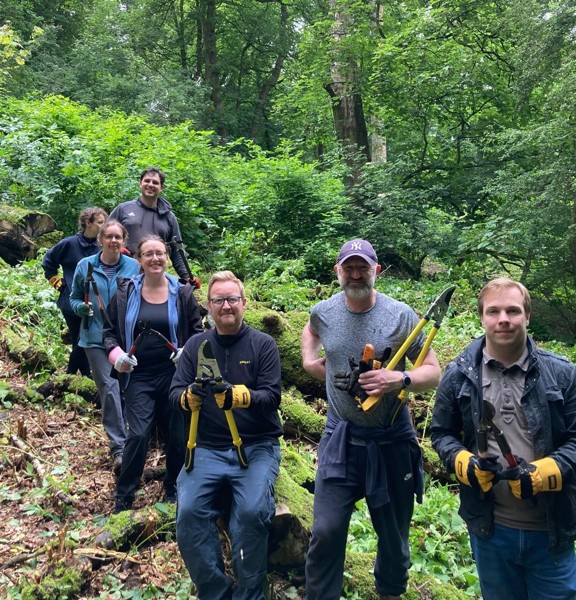Team away day in the forest with gardening tools