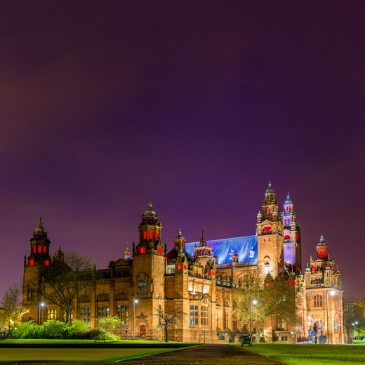 Dramatic night time view of the lit-up Baroque-style Kelvingrove Art Gallery and Museum
