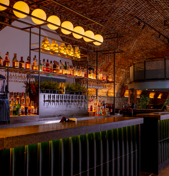 Contemporary bar area inside Platform Glasgow, featuring exposed brick arches and ambient lighting—perfect for corporate receptions and networking events.