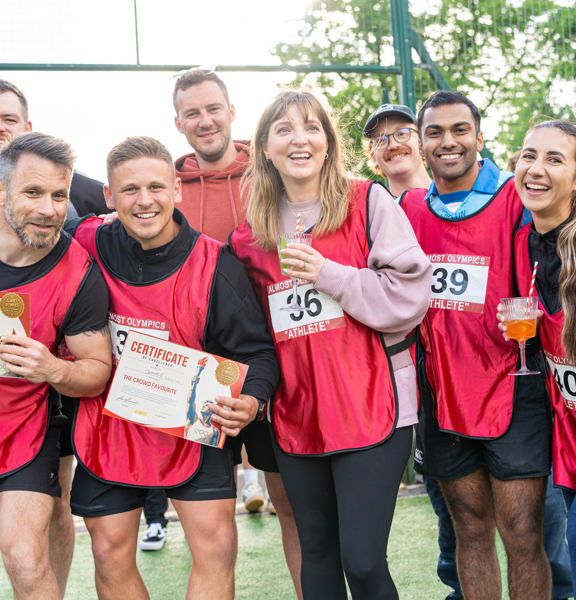Group of team mates following a game holding a certificate