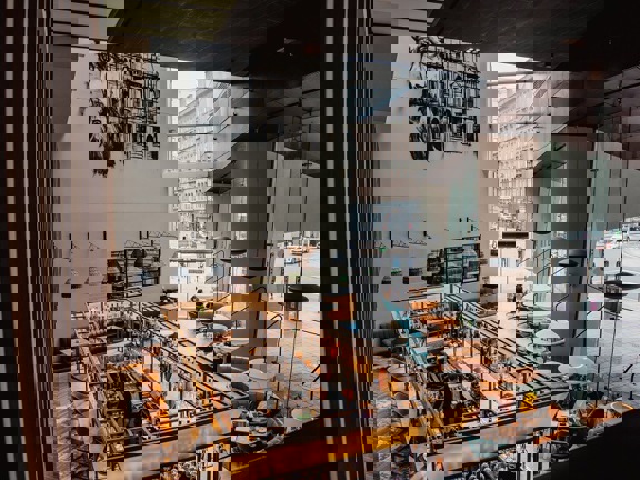 Birdseye view of The Grahamston Bar at Radisson Blu hotel - wooden and marble tiled flooring, floor to ceiling windows, leather and velvet armchairs.