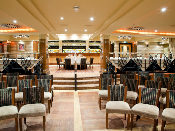 Venue space set up with cream velvet chairs in a semi circle