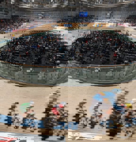 A group of cyclists race round the Sir Chris Hoy Velodrome.