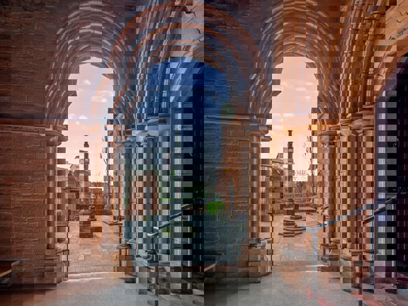 View from a venue via the ornate stone doorway onto a courtyard.