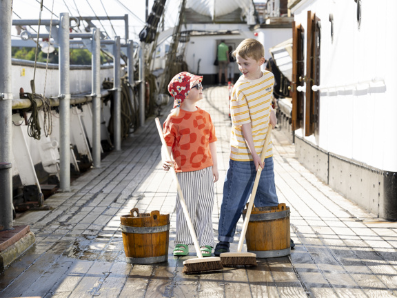 Kids scrubbing a deck