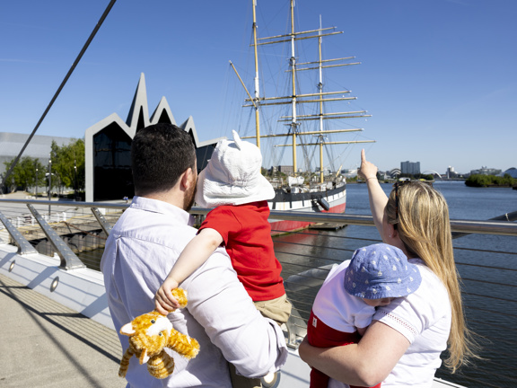 Family looking at The Tall Ship from a bridge