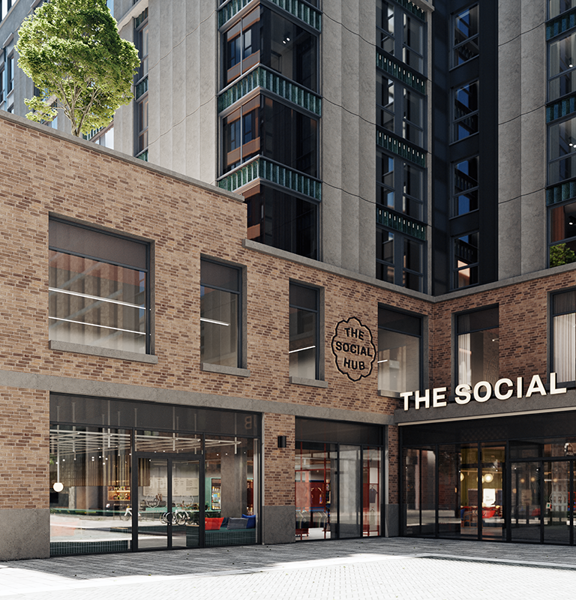 A digital mock up of the Social Hub's exterior shows a brown brick modern building with large windows over 2 floors. White lettering over the glass sliding doored entrance and branding on the buildings facade identify it. A grey multistorey building towers over it behind. The ground outside  the entrance and around the side of the building is paved and level.