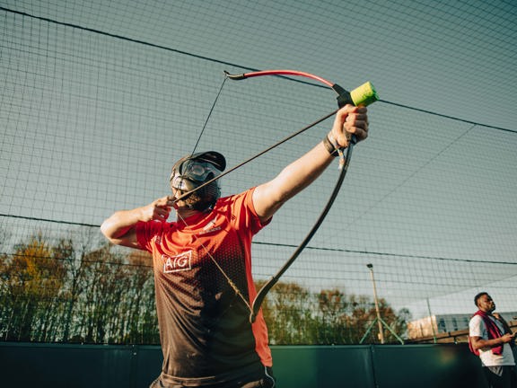 Person aiming a bow and arrow