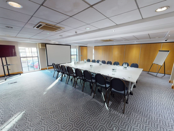 Meeting room set up boardroom style. 