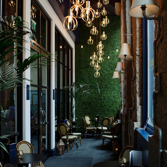 Stylish restaurant with plants and retro lightbulb chandelier