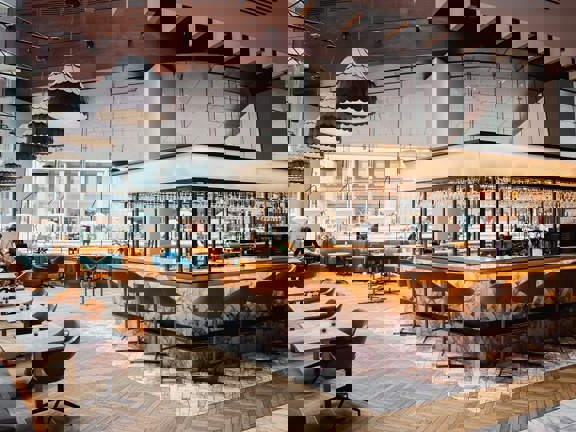 The Grahamston Bar at Radisson Blu hotel - wooden and marble tiled flooring, floor to ceiling windows, leather and velvet armchairs.