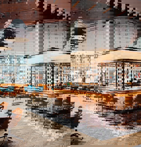 The Grahamston Bar at Radisson Blu hotel - wooden and marble tiled flooring, floor to ceiling windows, leather and velvet armchairs.