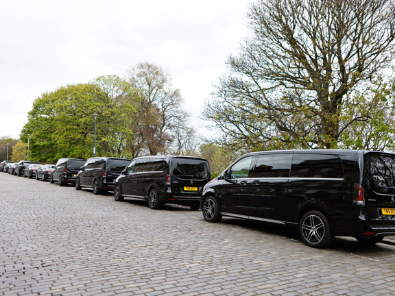 Row of parked Mercedes people carriers