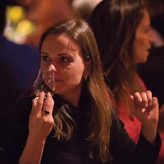 woman nosing a dram of whisky